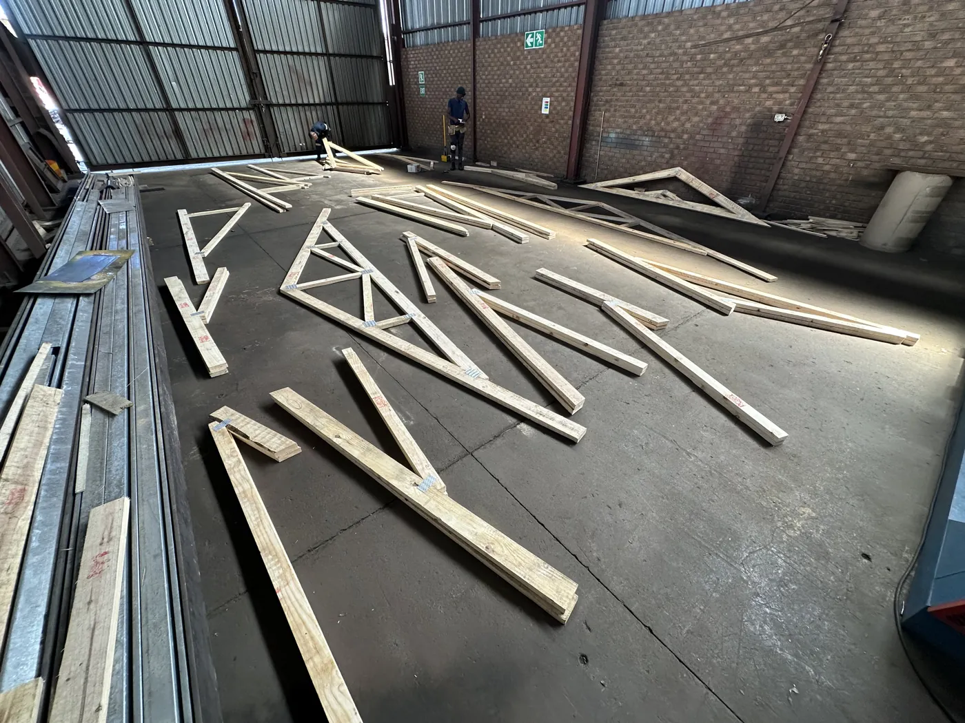 Timber roof trusses laid out on the factory floor in Middelburg